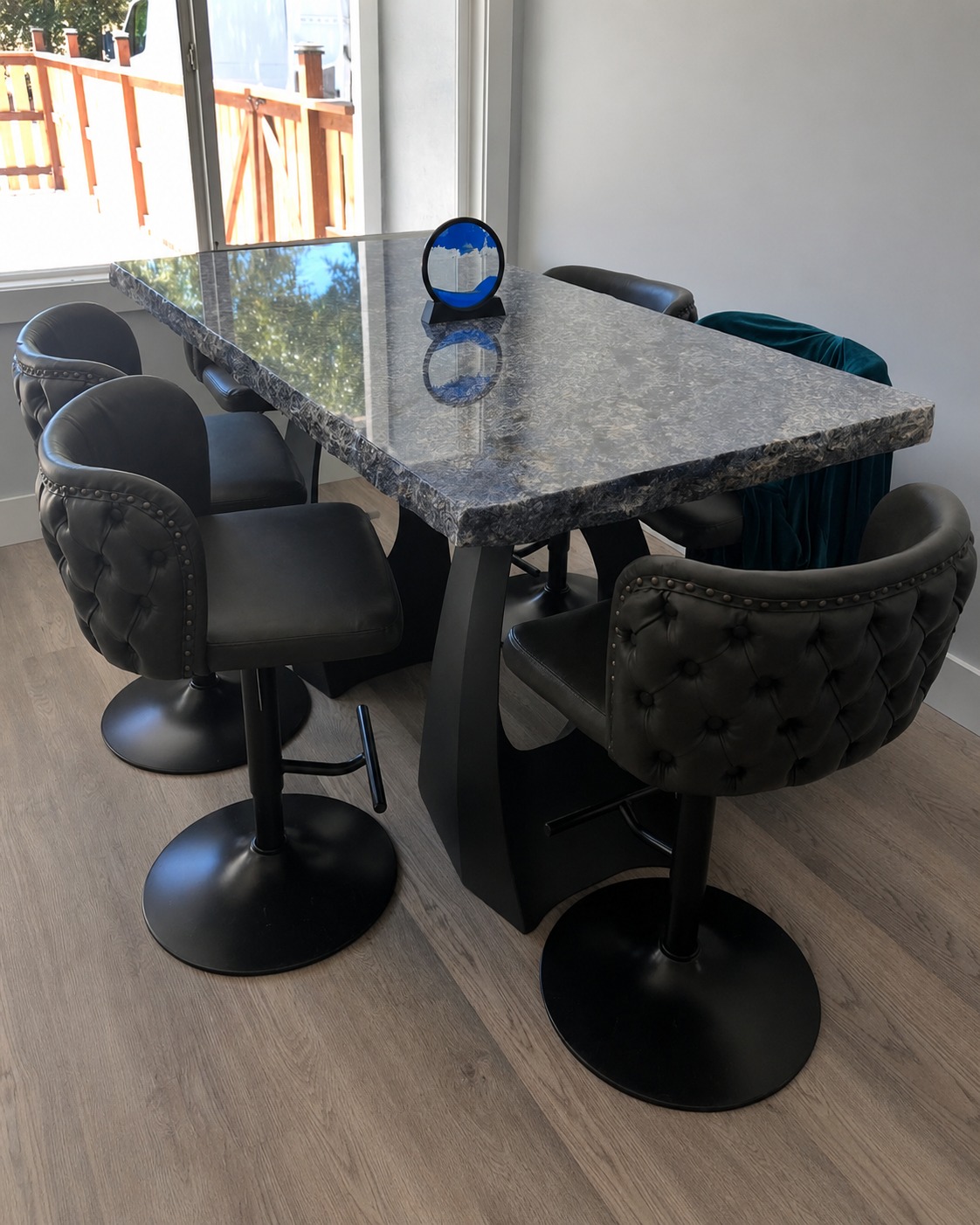 Custom granite dining table with tufted chairs